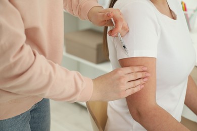 Photo of Diabetes. Woman getting insulin injection indoors, closeup