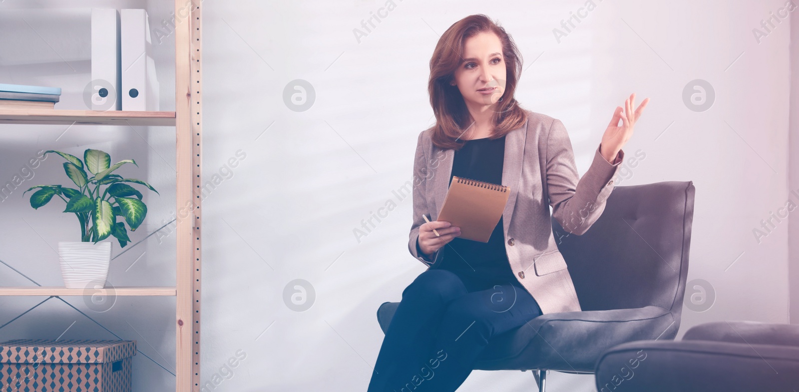 Image of Portrait of psychotherapist with notebook in office. Banner design