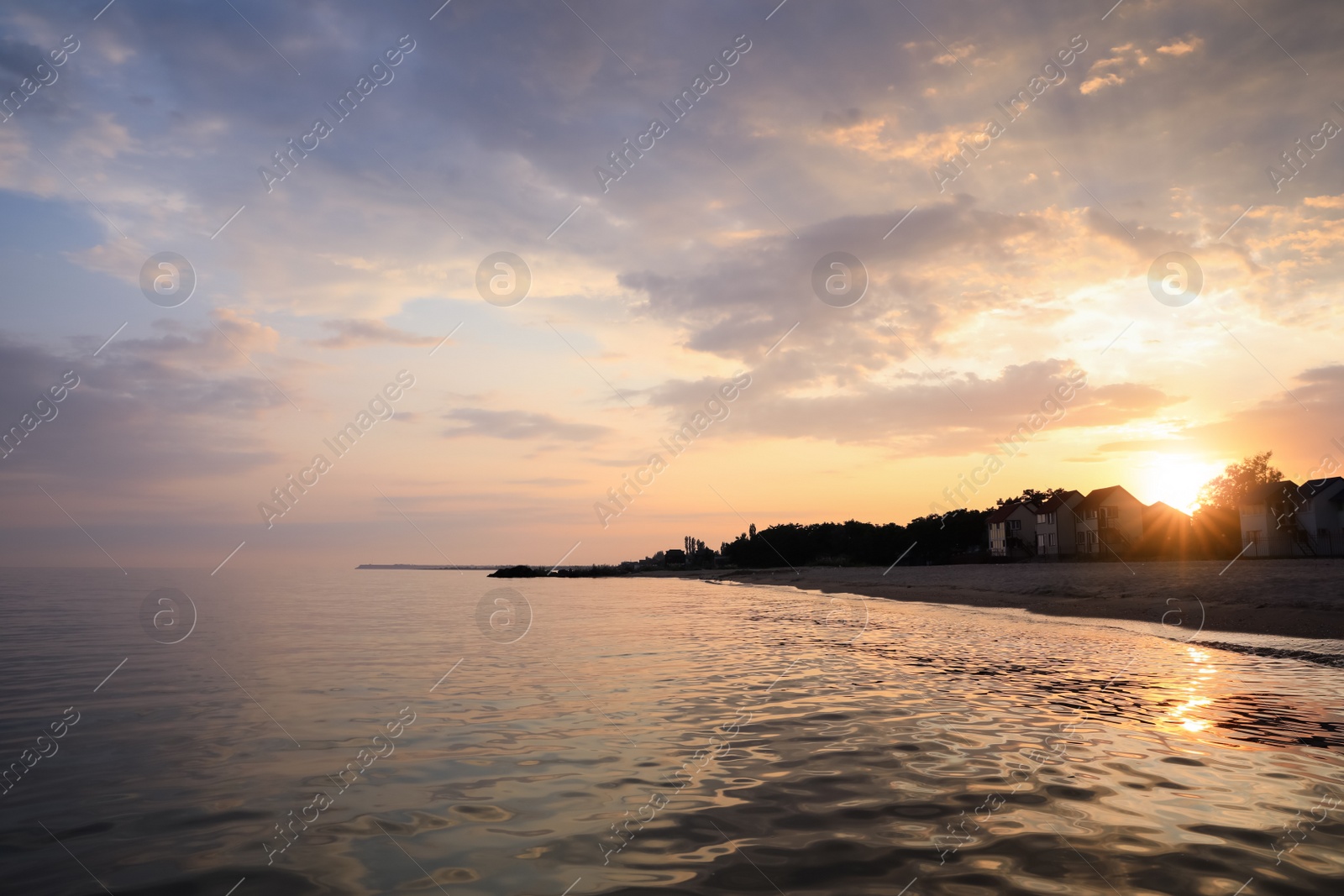 Photo of Picturesque view of sea and coast at sunset