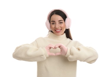 Photo of Beautiful young woman wearing earmuffs on white background