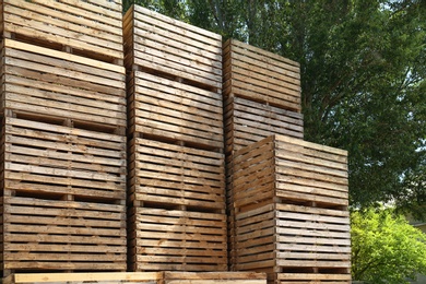 Photo of Pile of empty wooden crates outdoors on sunny day