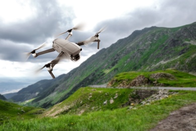 Image of Modern drone flying over picturesque mountains. Aerial survey