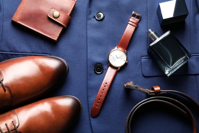 Photo of Flat lay composition with luxury wrist watch on blue shirt