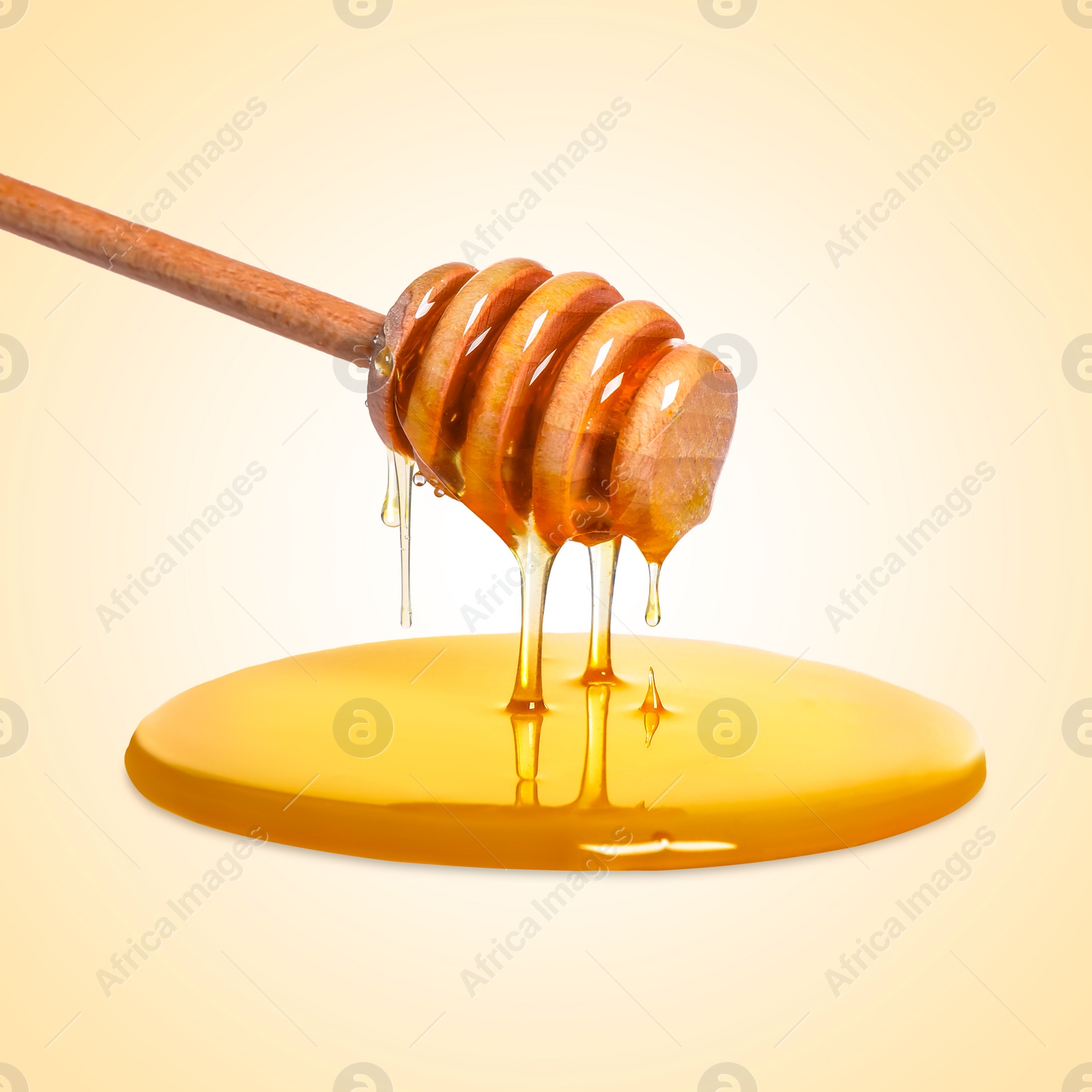 Image of Natural honey dripping from dipper on beige background