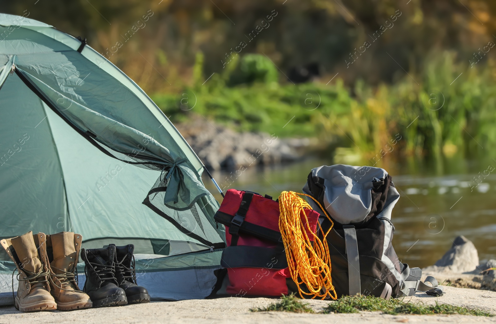 Photo of Set of equipment near camping tent outdoors