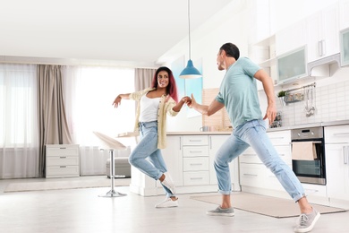 Photo of Beautiful couple dancing in kitchen at home