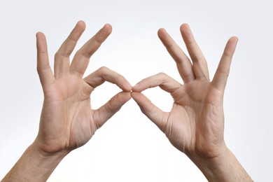 Photo of Man holding something in hands on white background, closeup