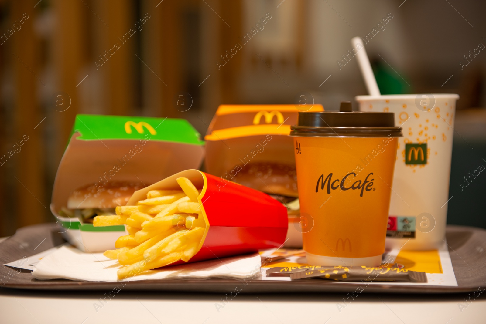 Photo of WARSAW, POLAND - SEPTEMBER 04, 2022: McDonald's French fries, burgers and drinks on table indoors