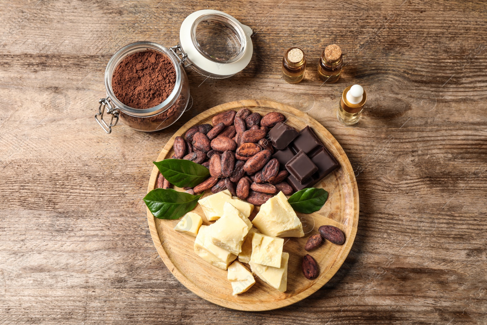 Photo of Flat lay composition with organic cocoa butter on wooden table