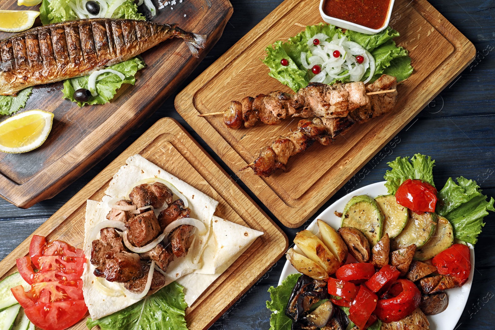 Photo of Flat lay composition with tasty grilled dishes on table