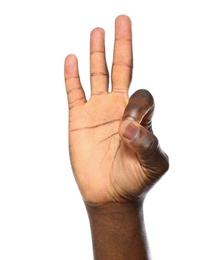 Photo of African-American man showing OK gesture on white background, closeup