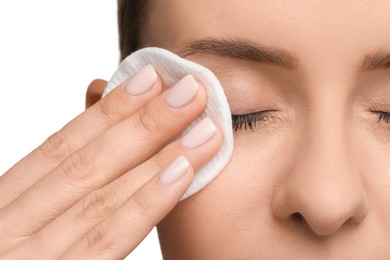 Woman removing makeup with cotton pad on white background, closeup