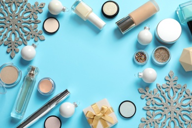 Photo of Flat lay composition with makeup products and Christmas decor on color background. Space for text