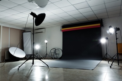 Photo of Interior of modern photo studio with professional lighting equipment