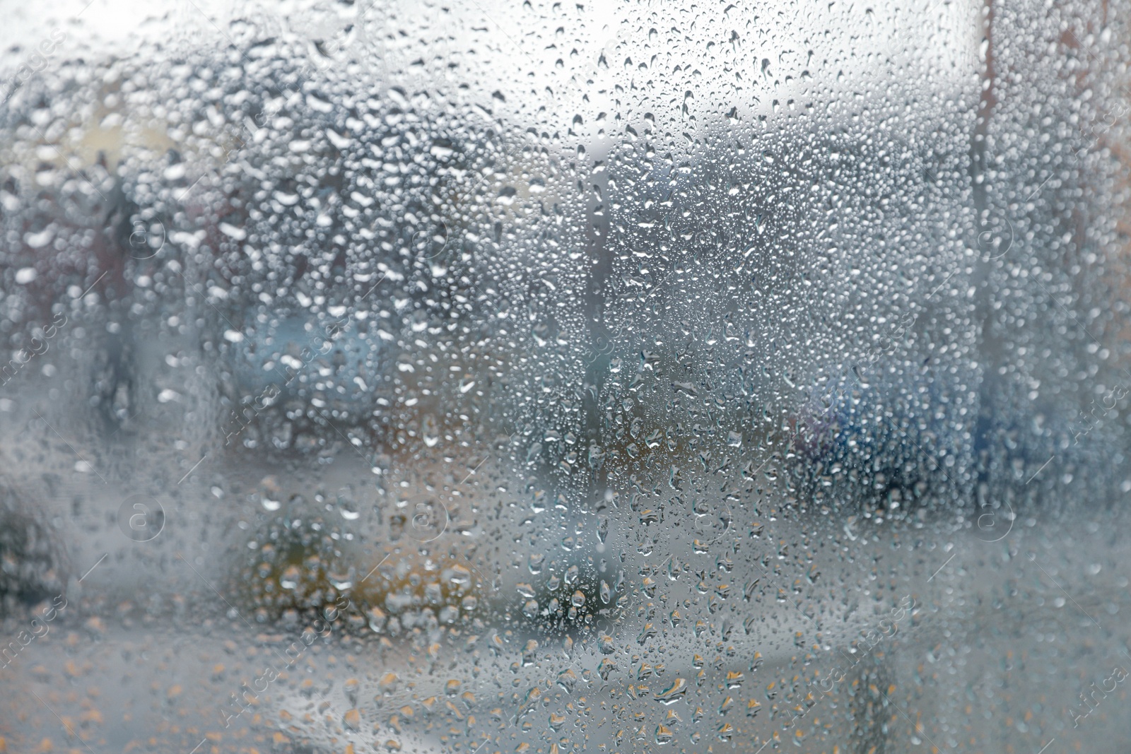 Photo of Closeup view of foggy window with rain drops