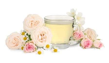 Photo of Aromatic herbal tea in glass cup and flowers isolated on white