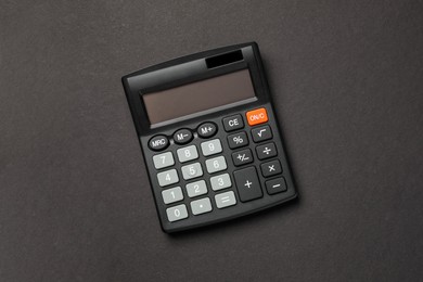 Calculator on black background, top view. Space for text