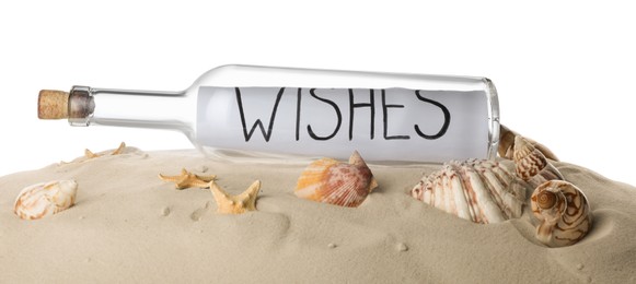 Photo of Corked glass bottle with Wishes note and seashells on sand against white background