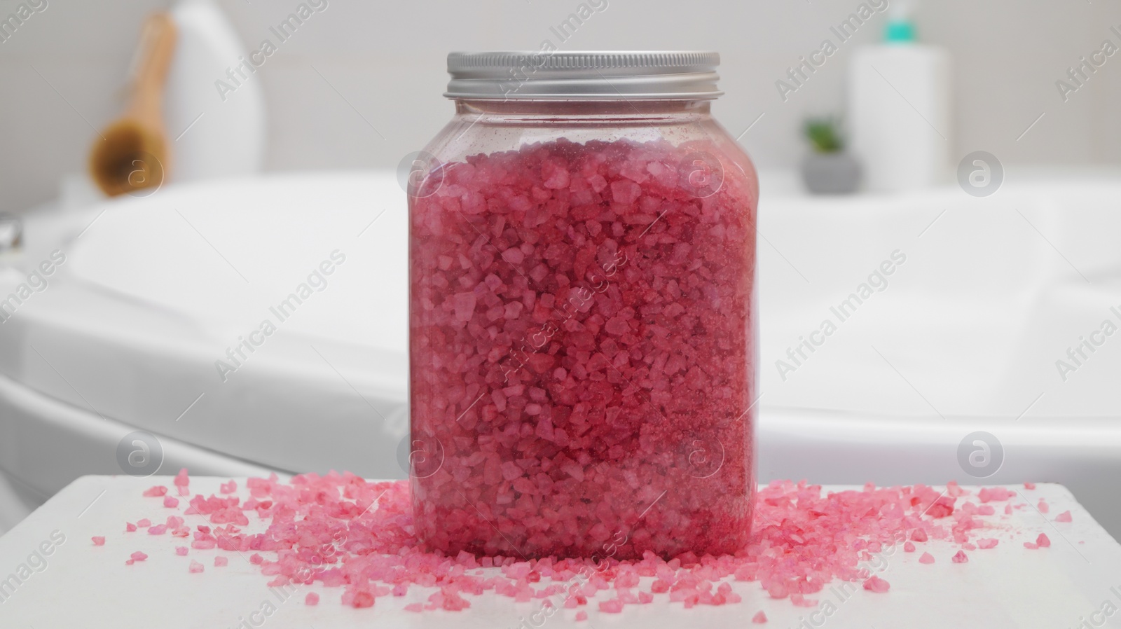 Photo of Jar with bath salt on table in bathroom, closeup