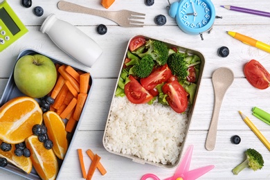 Flat lay composition with healthy food for school child on white wooden table