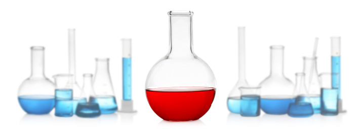 Image of Florence flask with red liquid near laboratory glassware on white background. Banner design