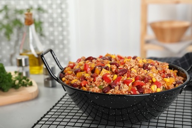 Pan with tasty chili con carne on gray table