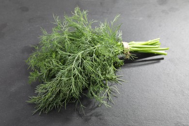 Bunch of fresh dill on grey table, closeup