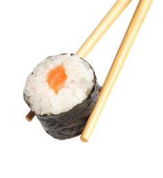 Photo of Chopsticks with tasty fresh sushi roll isolated on white