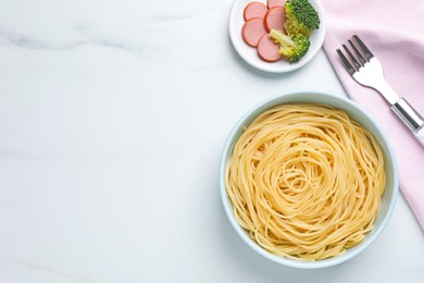 Photo of Tasty pasta served on white table, flat lay. Space for text