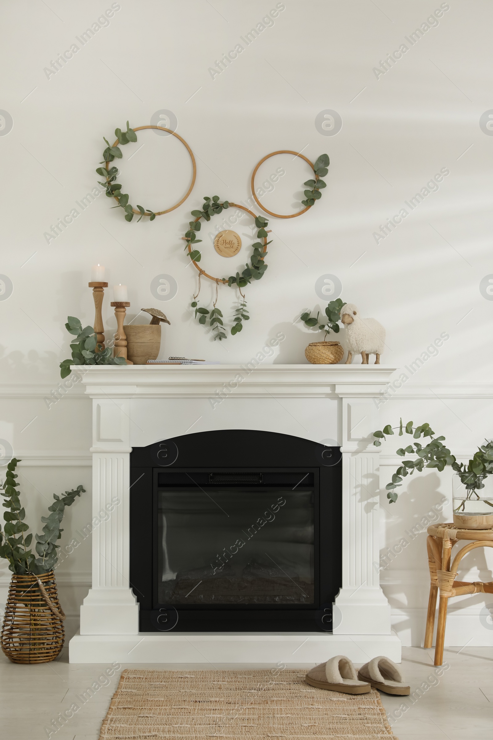 Photo of Stylish room with beautiful fireplace and eucalyptus branches