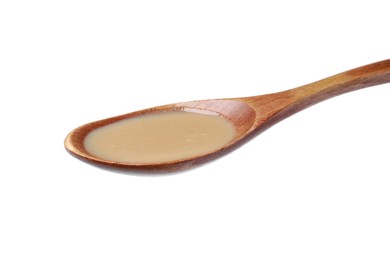 Photo of Spoon of tasty sesame paste isolated on white