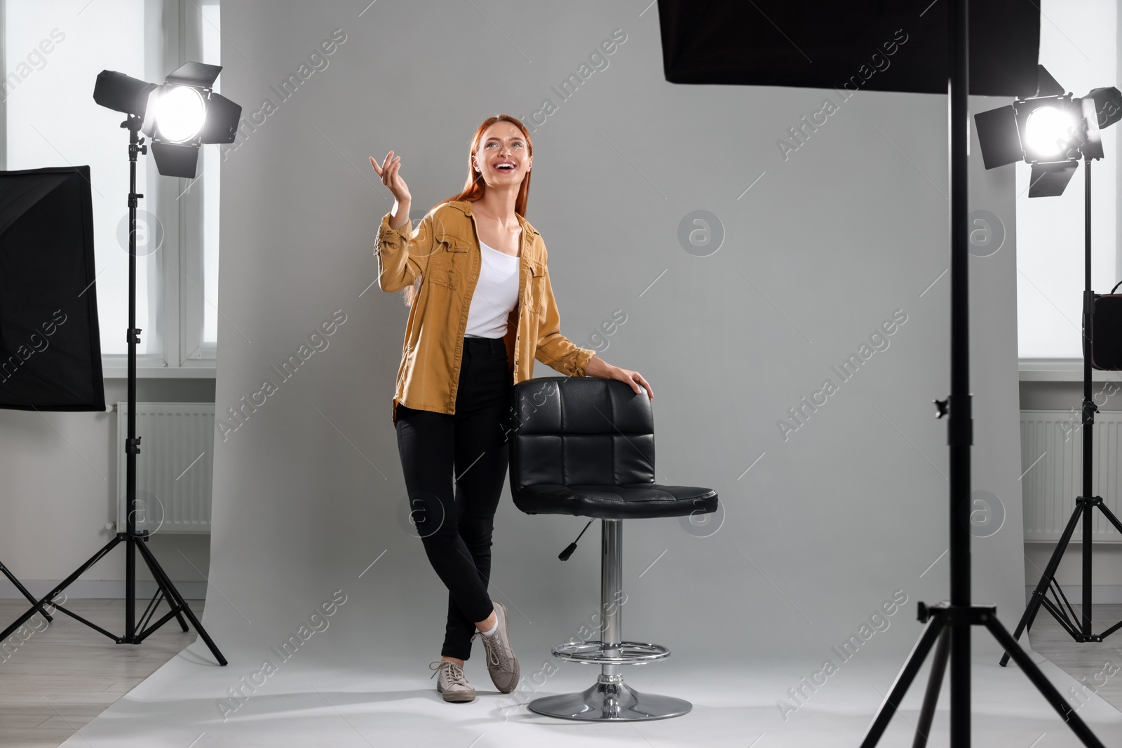 Photo of Casting call. Young woman performing on grey background