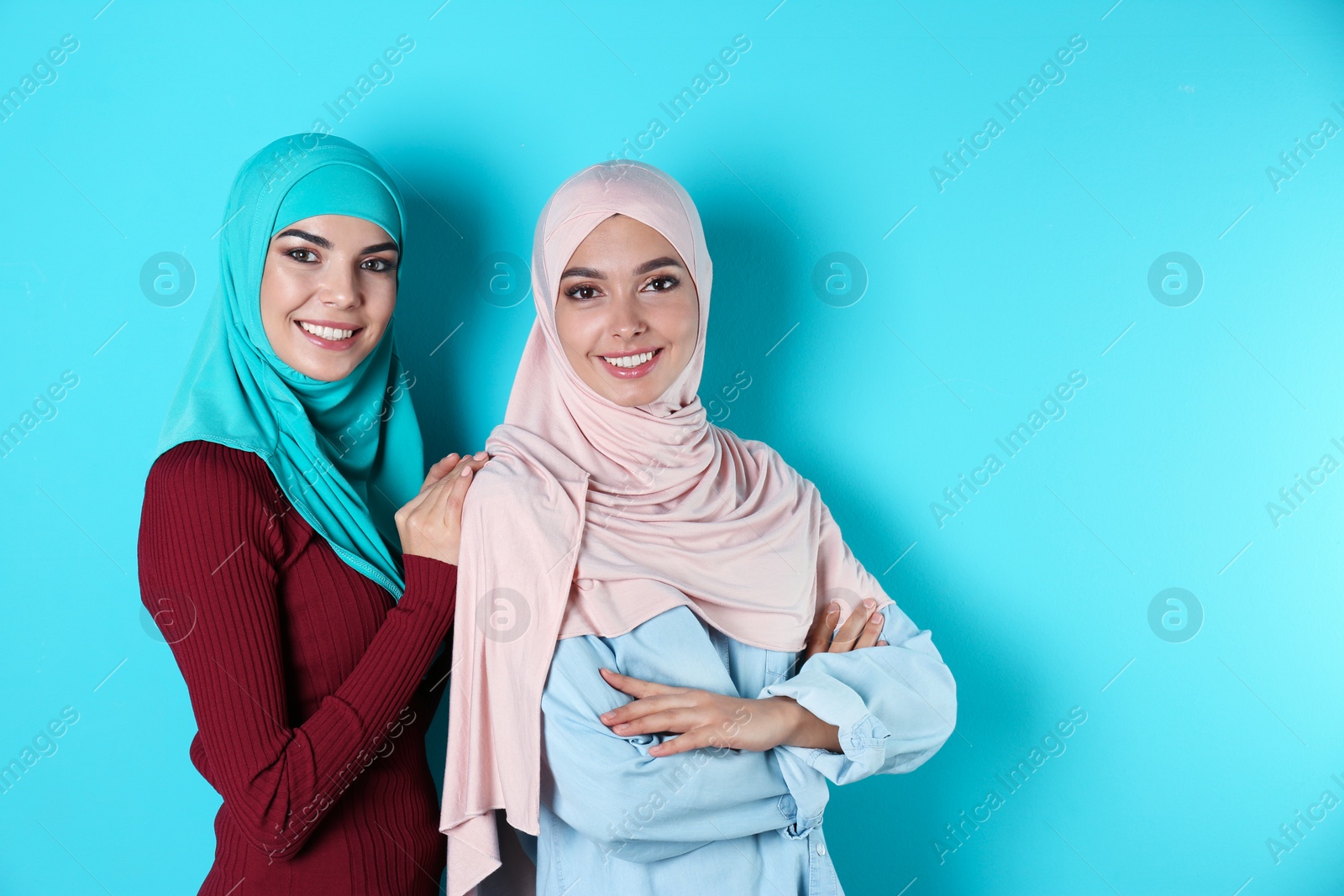 Photo of Portrait of young Muslim women in hijabs against color background