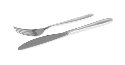 Photo of Shiny fork and knife on white background