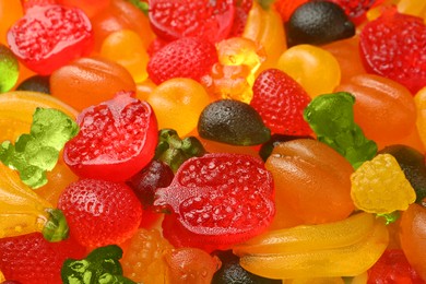 Mix of different delicious gummy candies as background, closeup