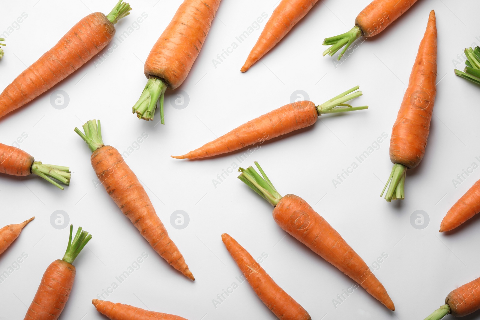 Photo of Flat lay composition with fresh carrots on color background