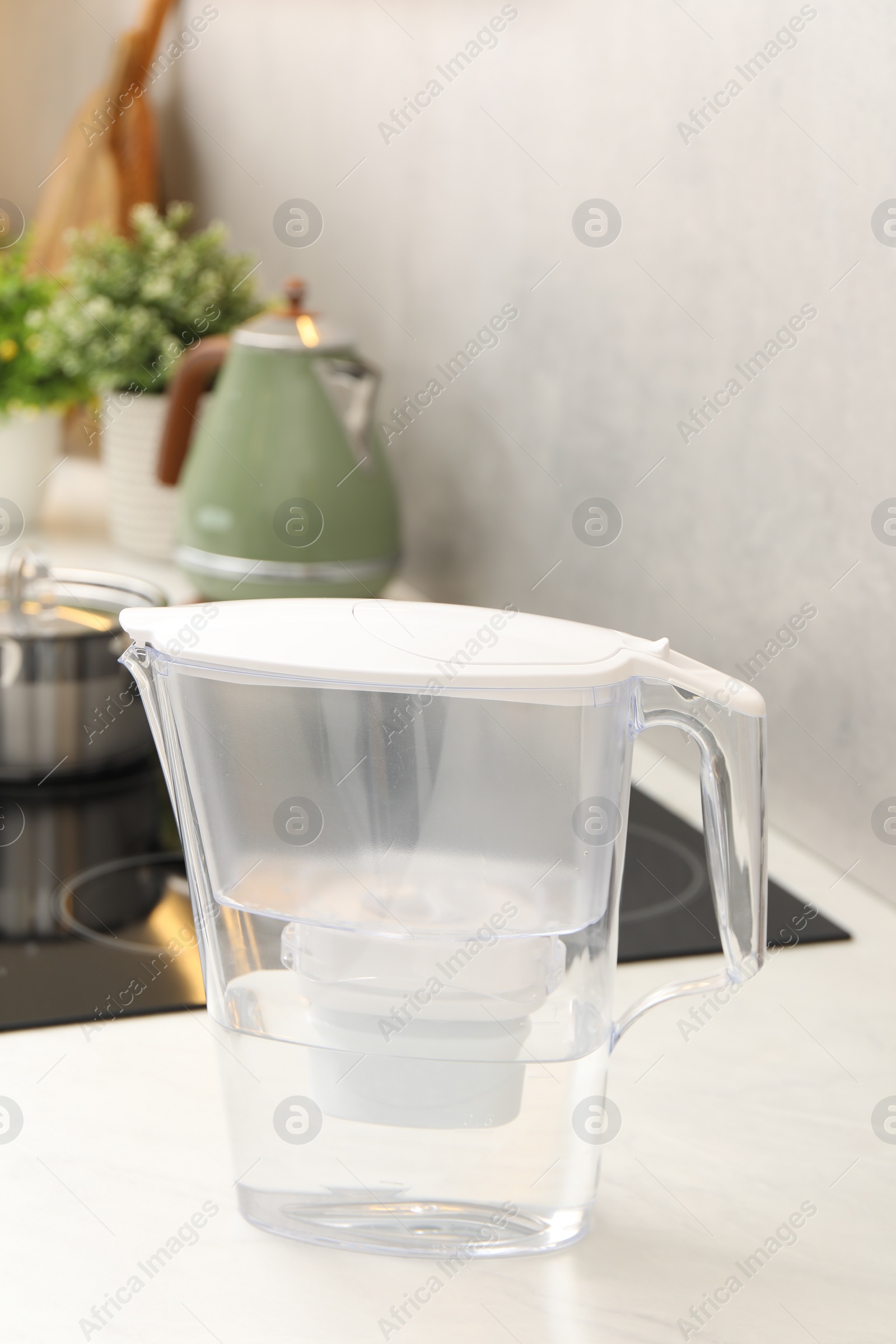 Photo of Water filter jug on white countertop in kitchen