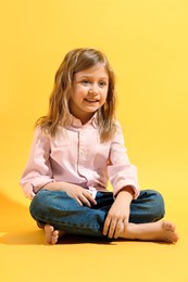 Fashion concept. Stylish girl posing on yellow background