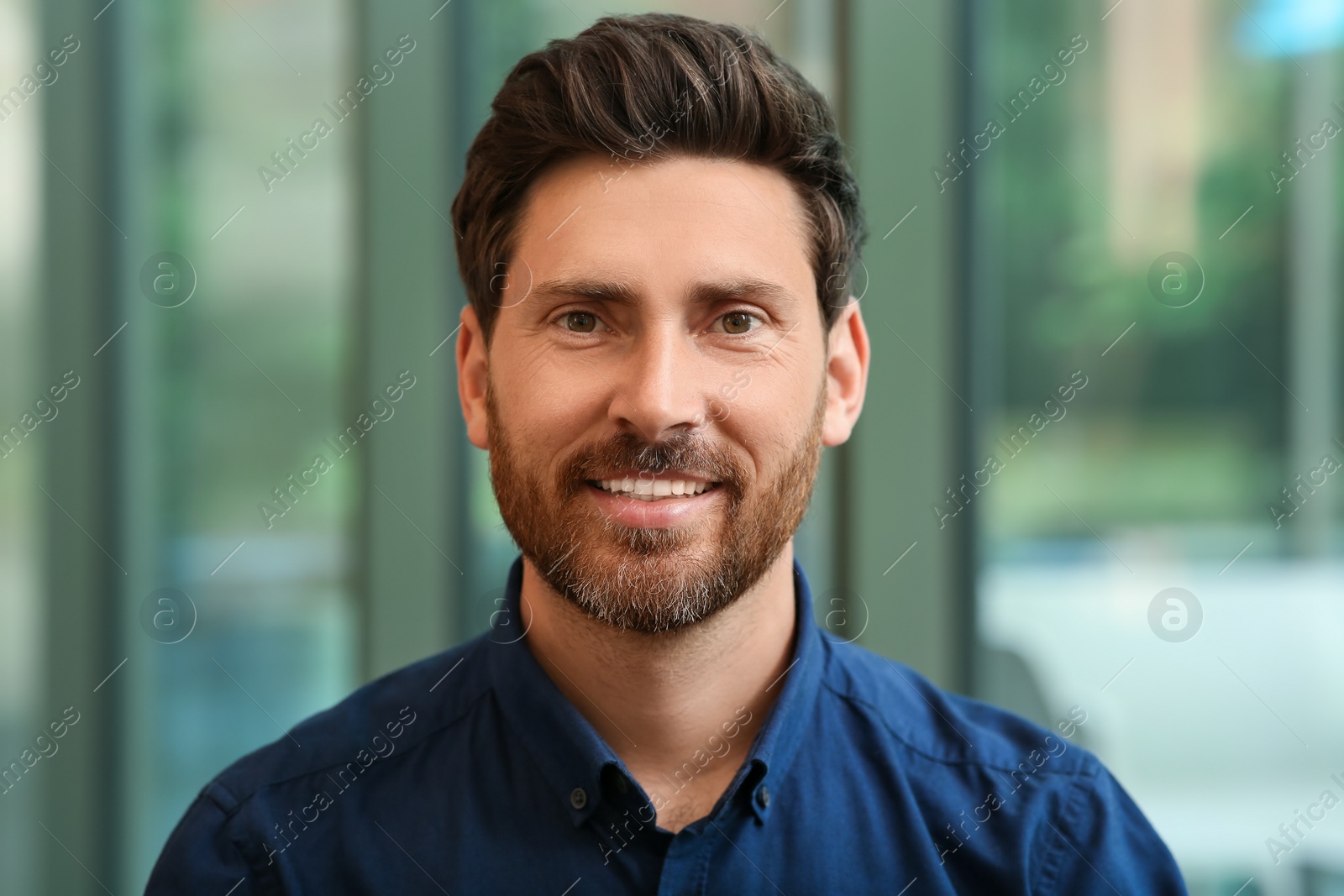 Photo of Portrait of handsome stylish man in office