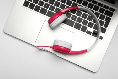 Photo of Modern headphones and laptop on white background, top view