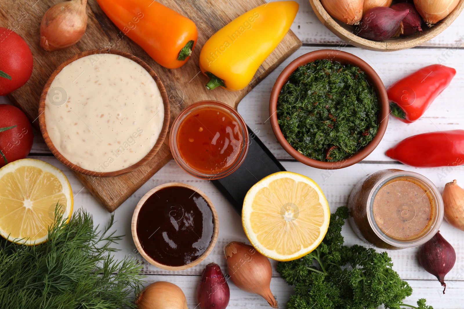 Photo of Different fresh marinades and ingredients on white wooden table, flat lay