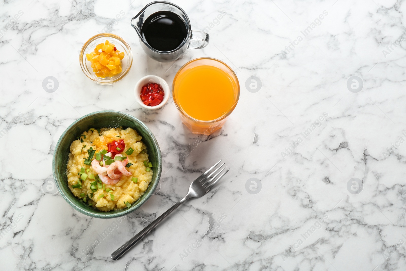 Photo of Bowl with fresh tasty shrimp and grits on table