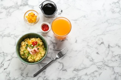 Bowl with fresh tasty shrimp and grits on table