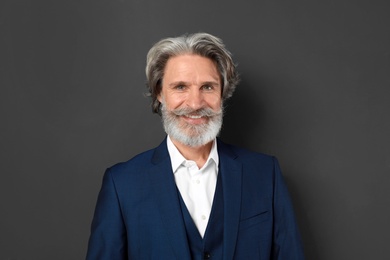 Portrait of handsome mature man on dark background