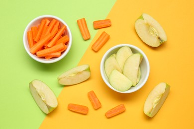 Photo of Fresh sliced carrot and apple on color background, flat lay. Finger food