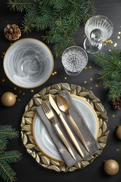 Photo of Elegant table setting on dark background, top view. Christmas celebration