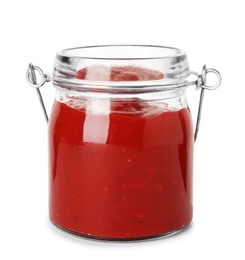 Photo of Glass jar with red sauce on white background