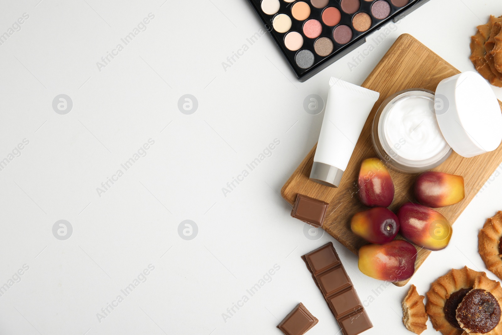 Image of Fresh ripe palm oil fruits, sweets and cosmetic products on white background, flat lay. Space for text