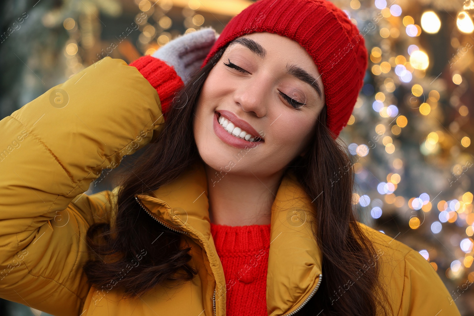 Photo of Portrait of smiling woman on blurred background. Winter time