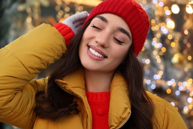 Portrait of smiling woman on blurred background. Winter time